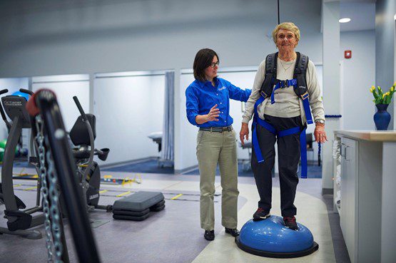 Woman using BOSU Ball in physical therapy