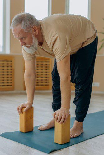 Man using yoga blocks for balance program