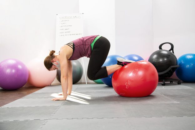 a woman using an exercise ball