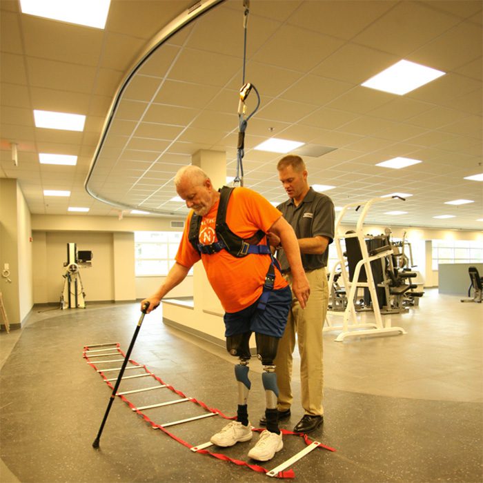 man using solo-step overhead track for rehab