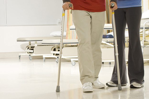 A patient uses walking poles