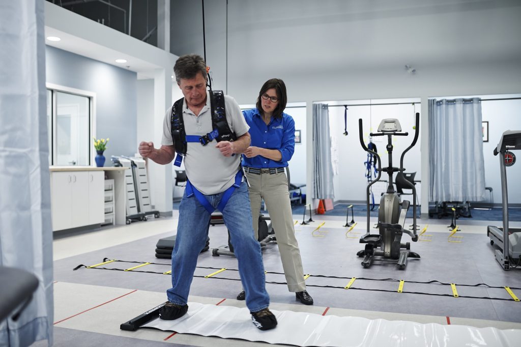 man working on slippery surface in physical therapy