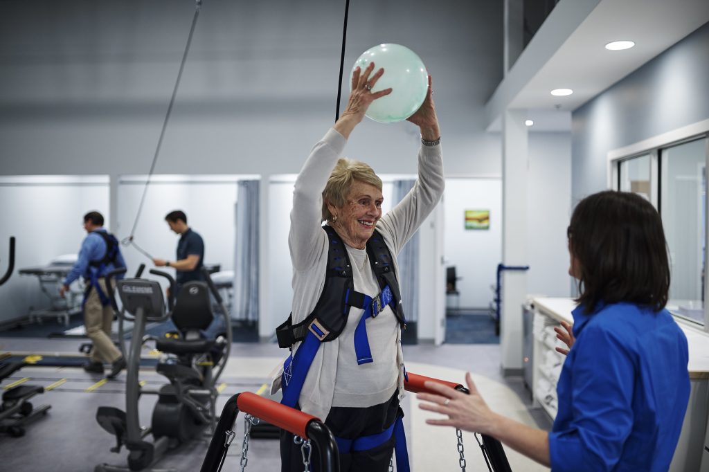Woman holding ball while in physical therapy