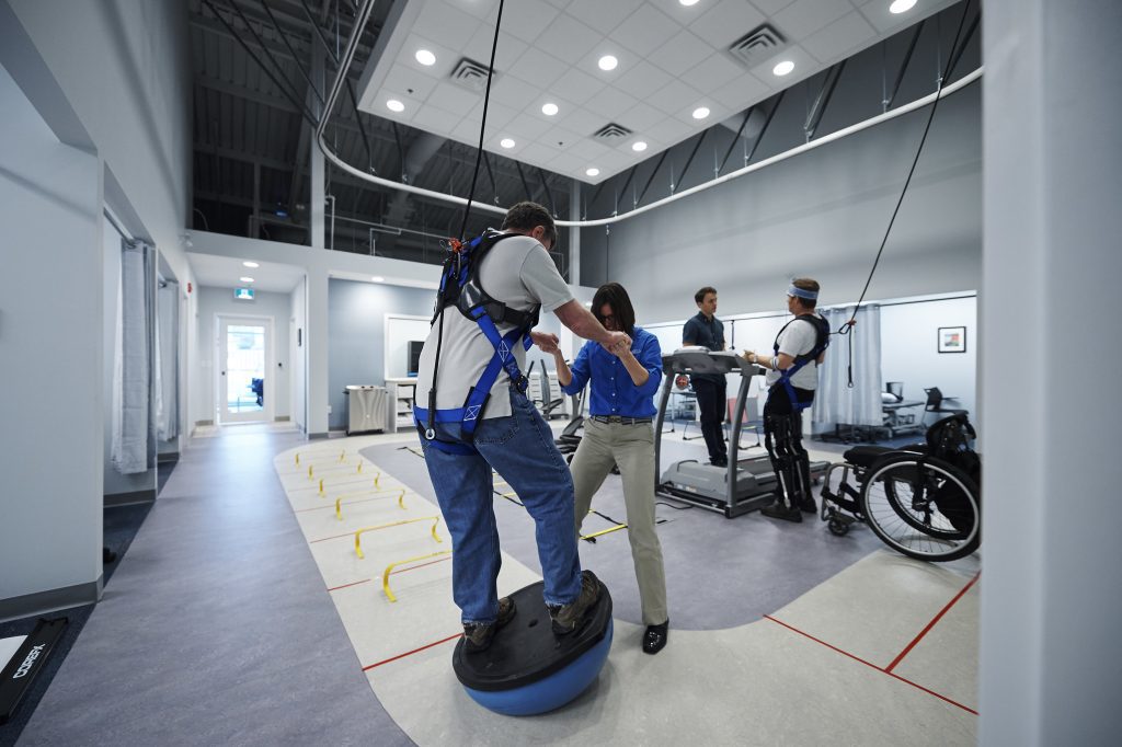 man using solo step harness while working on a bosu ball